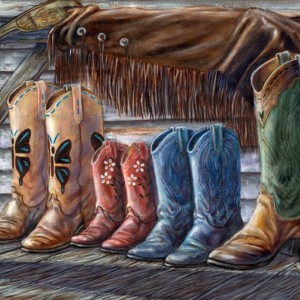 A family's boots sit next to each other on a wood porch
