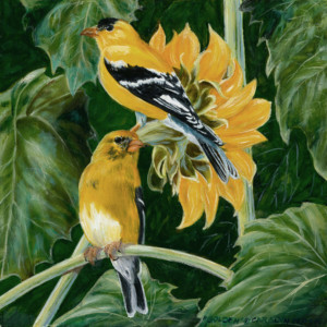 Two gold birds perched on leaves