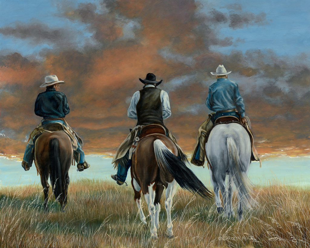Three cowboys ride off into the sunset