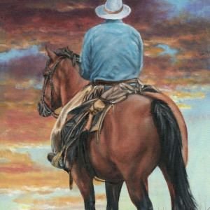 A cowboy rides into the sunset