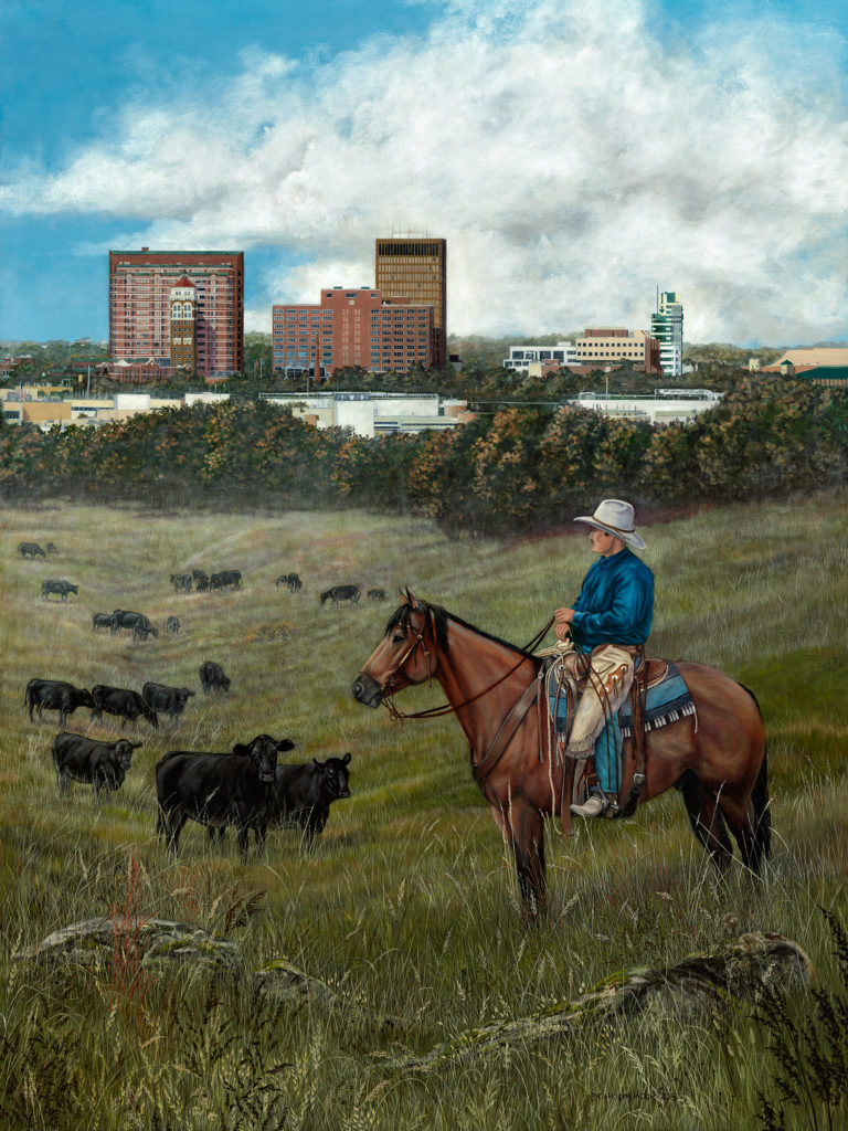A cowboy watches over his cattle, as a city looms in the background